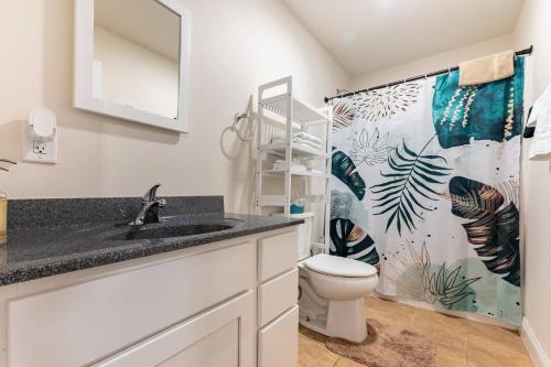 a bathroom with a toilet and a shower curtain at Modern & Stylish 1-BR Condo near Downtown in Boston