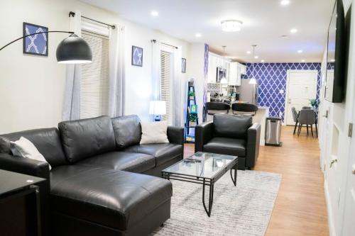 a living room with a leather couch and a table at Modern & Stylish 1-BR Condo near Downtown in Boston