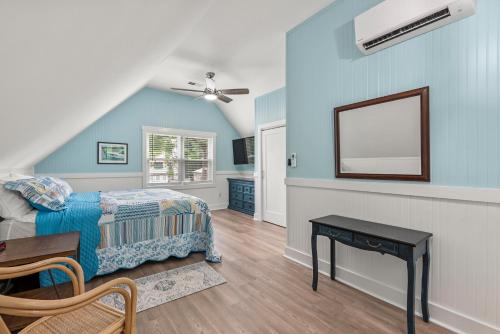 a bedroom with a bed and a mirror on the wall at Sunbeam Sands in Kill Devil Hills