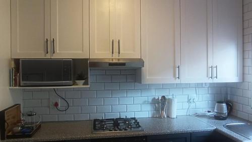 a kitchen with white cabinets and a counter top at Casa Clarity - Peaceful 1BR and Office Near Cape Town & Stellenbosch in Brackenfell
