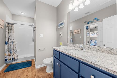 a bathroom with a sink and a toilet at Paradise Found Gulf Shores Beach Pools Dogs in Gulf Shores