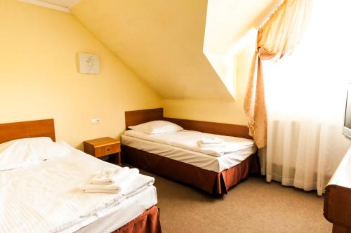 Кровать или кровати в номере Hotel Oleńka