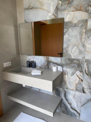 a bathroom with a sink and a mirror at La Villa K Marrakech jacuzzi chauffé in Marrakech