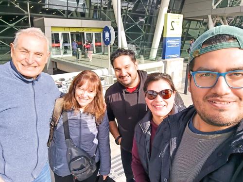 a group of people posing for a picture at an airport at Casa Familiar Rogiel Aeropuerto in Santiago