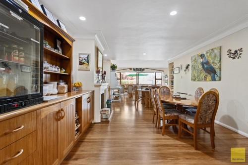 a kitchen and dining room with a table and chairs at Waitomo Caves Guest Lodge in Waitomo Caves
