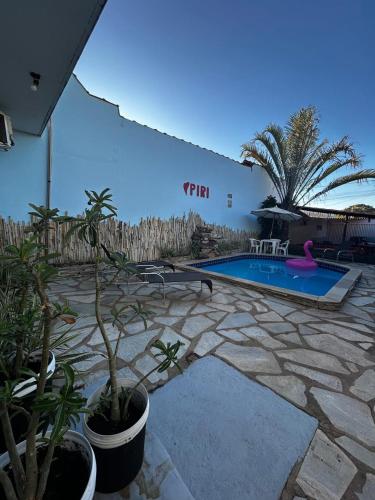 a patio with a swimming pool and some plants at Pousada Love Piri in Pirenópolis