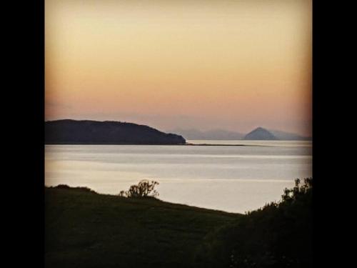 a view of a large body of water at sunset at Thornbank House in Stranraer