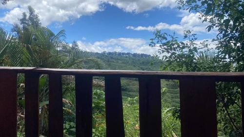 a balcony with a view of the jungle at Casa de campo Ecos del Poás in Dulce Nombre