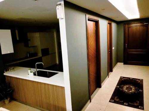 a kitchen with a sink and a counter top at Gold Crest Mall Prestigious Suites with Balcony by CityScape in DHA Lahore in Lahore