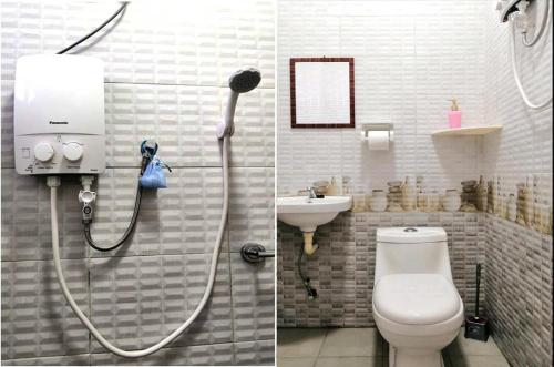 a bathroom with a shower and a toilet and a sink at Super Fully Furnished House next to airport - peaceful, leisure and quite in Langkawi Intl