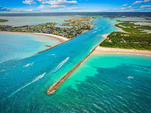 an aerial view of a beach with boats in the water at Sea Breeze Retreat in Fort Pierce