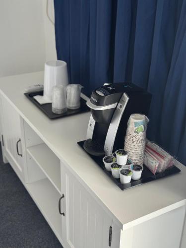 a coffee maker sitting on a counter with cups at Aurora Borealis in Saint Ignace