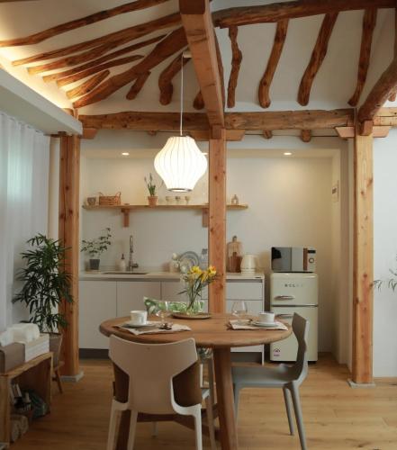 a kitchen and dining room with a wooden table and chairs at Stay Hosa in Suwon