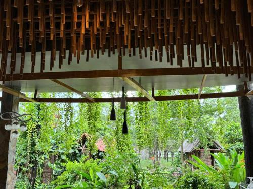 a view of a garden from the inside of a building at Bungalow HTC tuần châu in Ha Long