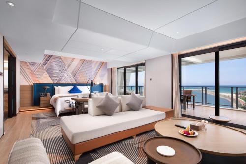 un soggiorno con un divano e una camera da letto di Lingshui Xiangshui Bay Summer Surfing Resort a Lingshui