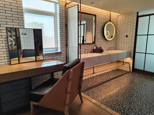 a bathroom with a sink and a mirror at Lingshui Xiangshui Bay Summer Surfing Resort in Lingshui