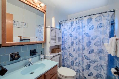 a bathroom with a toilet and a shower curtain at Bayshore Breeze Hampton-Buckroe Long Term Stay in Hampton