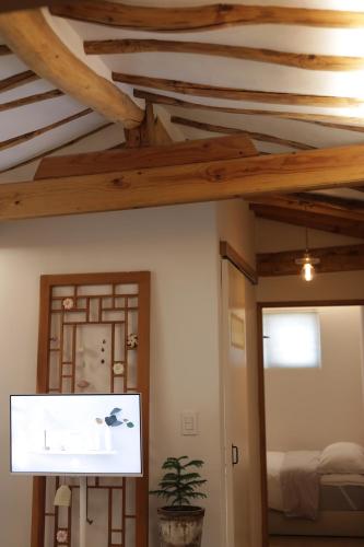 a room with a ceiling with wooden beams at Stay Hosa in Suwon