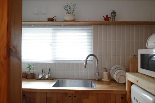 a kitchen with a sink and a window at Stay Hosa in Suwon