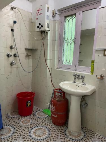a bathroom with a sink and a toilet and a window at Pema Guest House in Kathmandu