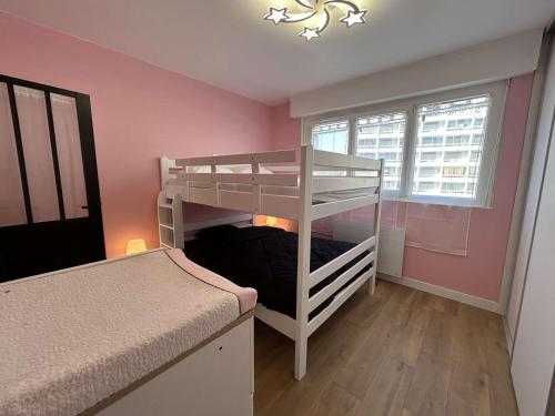 a bedroom with two bunk beds and a window at Appartement rénové 2 pièces avec WiFi en bord de mer - FR-1-224C-356 in Saint-Hilaire-de-Riez