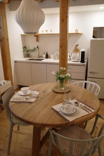 a kitchen with a wooden table with chairs and a dining room at Stay Hosa in Suwon