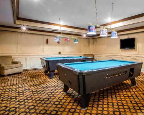 two pool tables in a room with a tv at Ramada by Wyndham Birmingham Airport in Birmingham