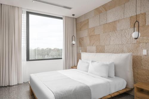 a bedroom with a large white bed and a window at Luxury Two Bedroom with Vineyard Views The Reserve Retreat U10 in Mount View