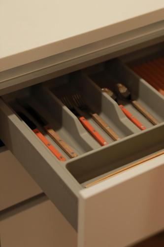 a drawer in a desk with chopsticks in it at Stay Hosa in Suwon