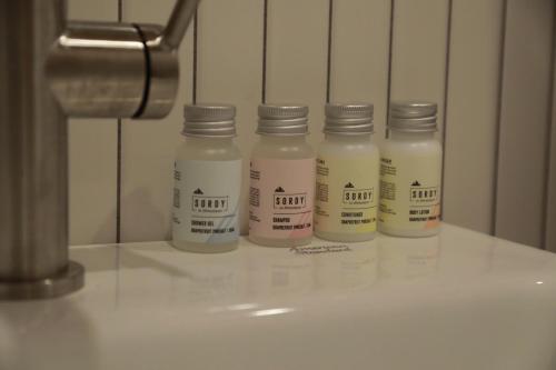 a group of four bottles of milk sitting on a counter at Stay Hosa in Suwon