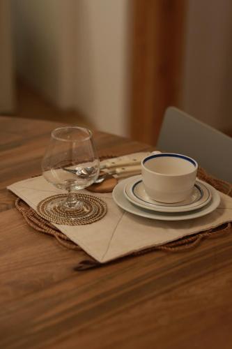 a table with a plate and a wine glass on it at Stay Hosa in Suwon