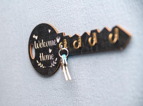 a black heart shaped keychain with the words welcome home at The Whitehouse M6, Junction 10 With Parking in Walsall