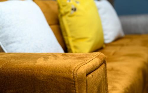 a close up of a couch with pillows at The Whitehouse M6, Junction 10 With Parking in Walsall