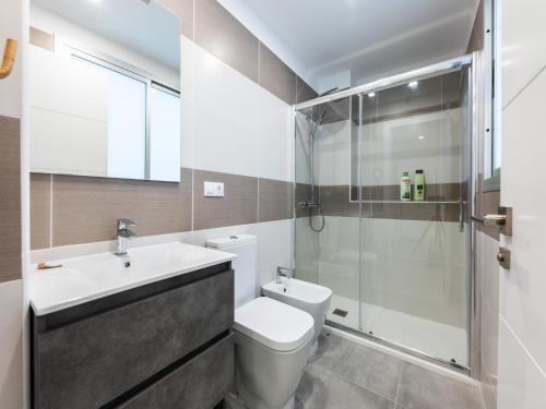 a bathroom with a toilet sink and a shower at House in Las Palmas near Playa de Las Canteras in Las Palmas de Gran Canaria