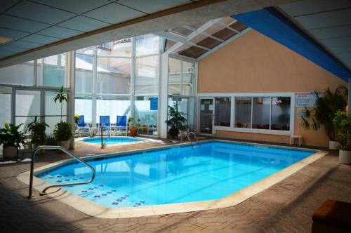 a large swimming pool in a building with a large window at The White Sands Resort and Spa in Point Pleasant Beach