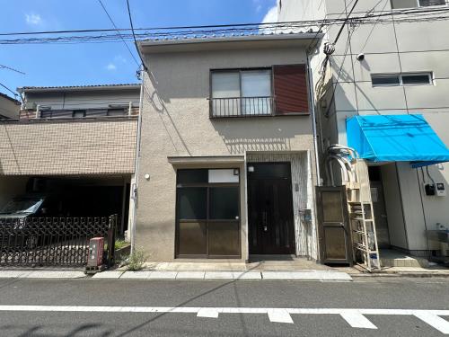 a building with a door on the side of a street at Asakusa Riverside Family Inn in Tokyo