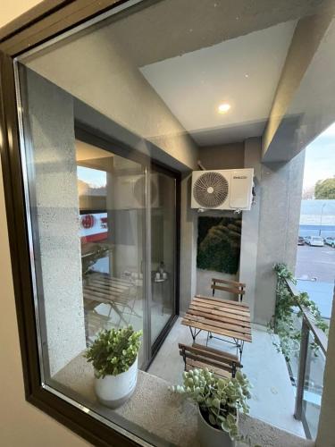 a view of a balcony with a bench and a table at Andes Nomad Mendoza in Godoy Cruz
