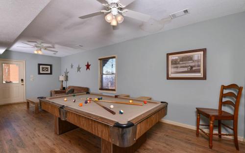 a pool table in a living room with a ceiling fan at Sky High in Gatlinburg