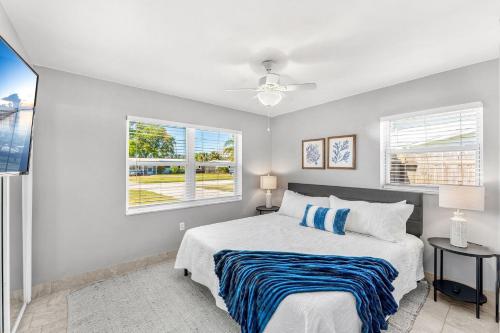 a bedroom with a bed and two windows at 721 Java Rd in Cocoa Beach