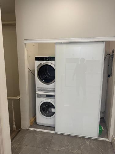 a washing machine and a washer and dryer in a room at King-Queen Walk-in Residence - Walk to CN TOWER,SUBWAY,CONCERTS,PUBS,PARKING in Toronto