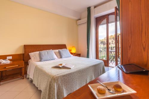 a hotel room with a bed and a balcony at Hotel Orsa Maggiore in Vulcano