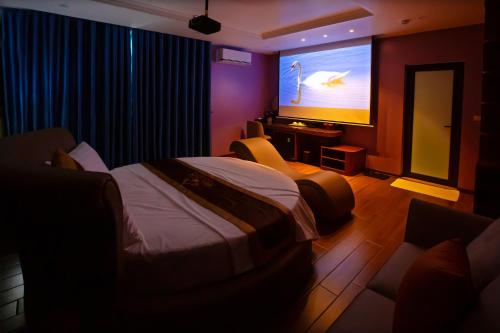 a hotel room with a bed and a large screen at Hoa Nam Hotel Việt Hưng in Long Biên