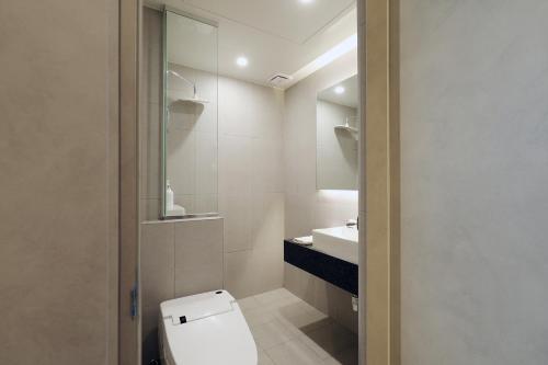 a bathroom with a toilet and a sink at Hound Hotel Asan Terminal in Asan