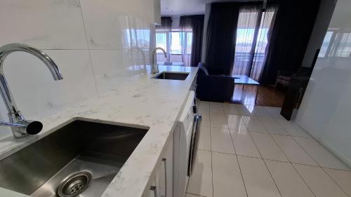 a kitchen with a sink and a counter top at Exodus Dandenong Apartment Hotel in Dandenong