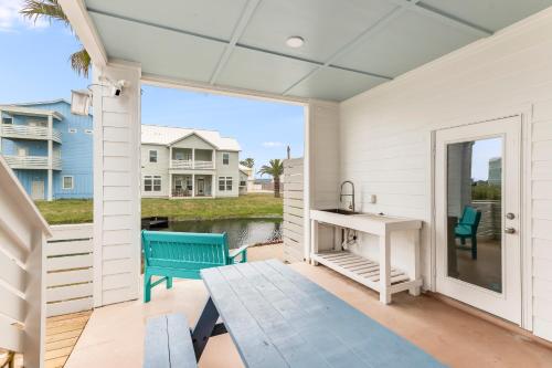 a screened porch with a desk and a bench at Cute As Shell IPE125 in Padre Island