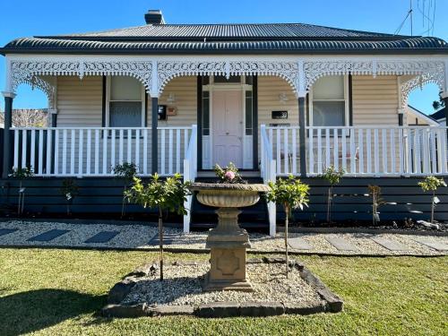 a house with a fountain in front of it at Courthouse - Family Retreat Near Bendigo CBD in Bendigo