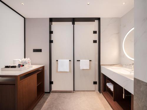 a bathroom with a shower and a sink at Hilton Garden Inn Taiyuan Jiefang Road in Taiyuan