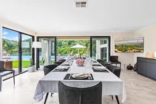 a large white dining room with a long white table at Maleny Chateau Pool Country Experience, Creek, Gym in Balmoral Ridge