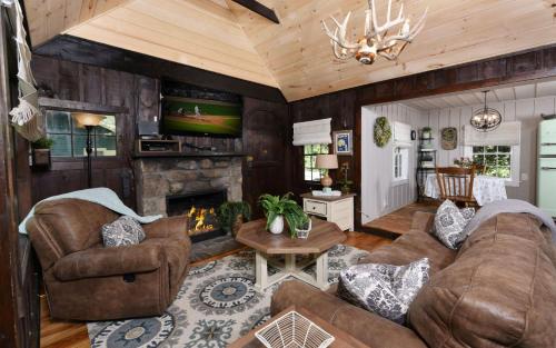 a living room with a couch and a fireplace at On the River in Gatlinburg