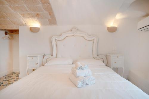 a bedroom with two beds with towels on them at Luxury Palazzo Principessa - Elegance and History in Center in Monopoli